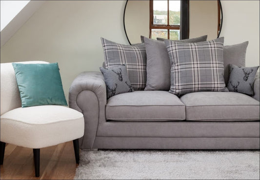 gray sofa bed with a mirror behind